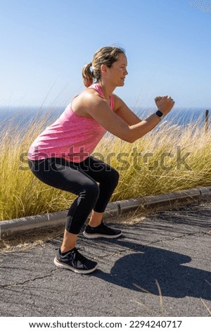side view of a woman doing squats