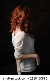 Side View Of Woman With Long Curly Ginger Hair