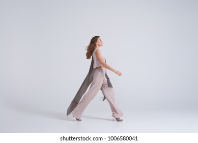 Side View Of Woman Model Walking In Trend Clothing