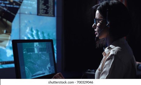 Side View Of Woman Sitting And Working At Computer In Space Mission Control Center. Some Elements Of This Image Furnished By NASA.