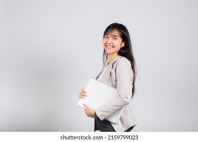 Side View Woman Smiling Confident Smiling Holding Closed Laptop, Portrait Excited Happy Asian Young Female Person Hugging Close Cover Computer Device Studio Shot Isolated On White Background