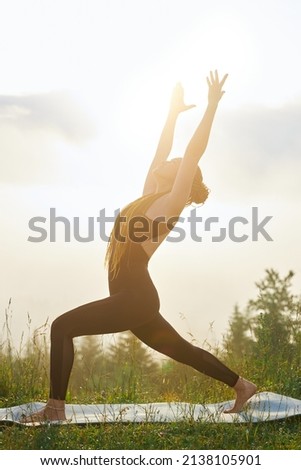 Similar – Young woman doing yoga in nature