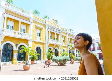 Side View Of Woman Traveling In Cartagena De Indias. Horizontal View Of Latin Woman Sightseeing In Spanish Historic Ancient City. Travel To Colombia Concept.