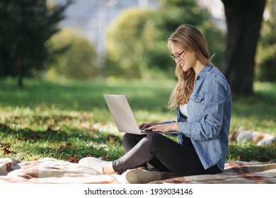 Side View Of Woman Working On Laptop At Park