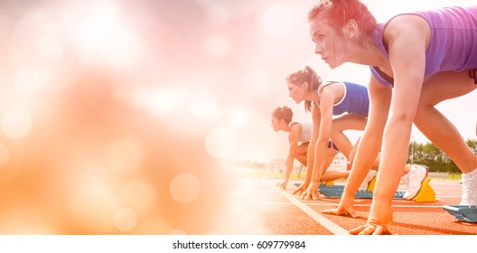 Side View Of Women On Starting Line Of Track Field