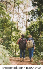 Side View Of Wonderlust Couple Walking Through Forest 