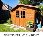 Side view of wooden garden shed glased in teak color