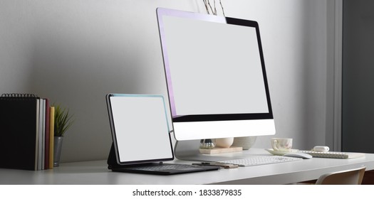Side view of worktable with tablet, computer and office supplies in office room, include clipping path