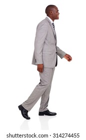 Side View Of Young African American Businessman Walking