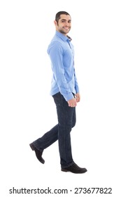 Side View Of Young Arabic Bearded Business Man In Blue Shirt Walking Isolated On White Background