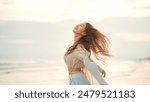 Side view of young asian woman with freedom on the sea beach at golden sunset, Female tourist on seaside summer vacation