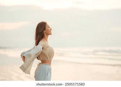 Side view of young asian woman with freedom on the sea beach at golden sunset, Female tourist on seaside summer vacation, Go Everywhere. - Powered by Shutterstock