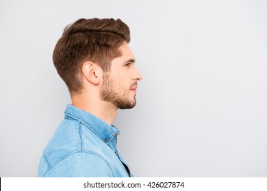 Side view of young bearded man isolated on gray background - Powered by Shutterstock