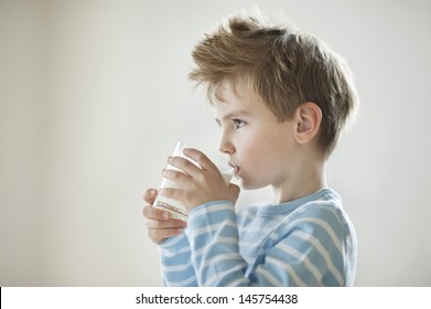 Side View Of A Young Boy Drinking Milk