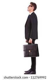 Side View Of A Young Business Man Or Student Looking Up - Full Body Picture