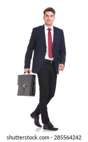 Side View Of A Young Business Man Holding A Brief Case While Walking On Isoaed Background.