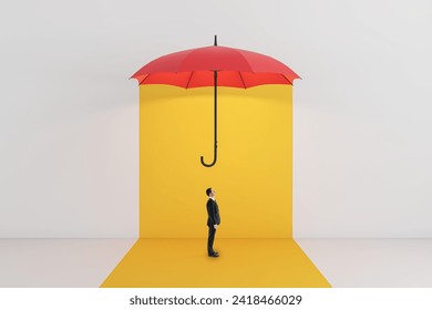 Side view of young businessman standing under red umbrella on yellow background. Protection and insurance concept - Powered by Shutterstock