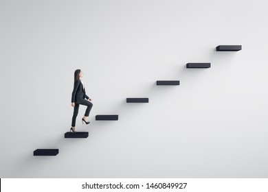 Side view of young businesswoman climbing stairs to success on concrete wall background. Leadership and career development concept - Shutterstock ID 1460849927