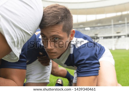 Side view of young Caucasian male rugby players ready to play rugby match in stadium