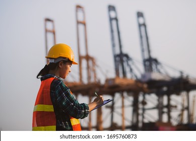 Side view of young engineer woman wear safety helmet are record inspector.  blur background, concept of renewable energy