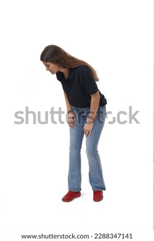 side view young girl crouching and looking the floor on white background