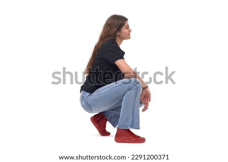 side view of a young girl long-haired sitting squatting on white background