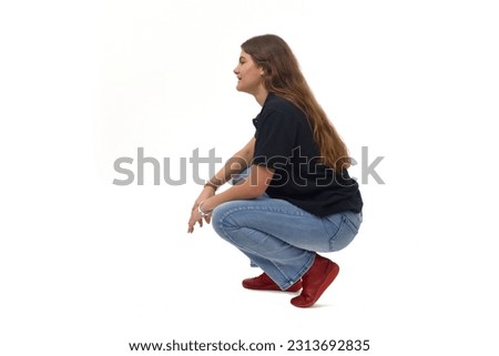 side view of a young girl long-haired sitting squatting on white background