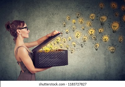 Side View Of Young Happy Woman Holding A Box With Brilliant Ideas Spreading Knowledge 