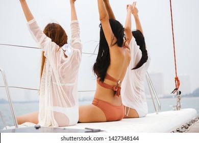 Side View Of Young Long-haired Women In Colorful Bikini Dancing On Yacht In Calm Sea