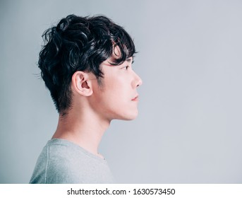 Side View Of Young Smiling Handsome Man Isolated On Gray Background