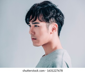 Side View Of Young Smiling Handsome Man Isolated On Gray Background