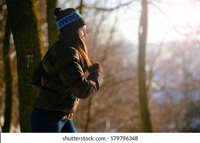 Side View Of Young Sporty Woman Running In Winter Sunny Day. Winter Sports, Outdoor Fitness,  Workout, Health Concept.