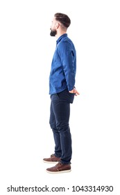 Side View Of Young Stylish Bearded Man With Hands In Back Pockets Standing And Watching. Full Body Isolated On White Background.