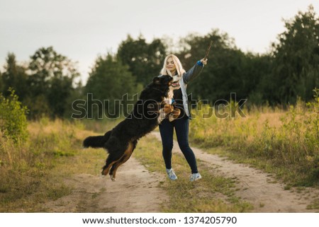 Similar – Attractive smiling blond woman with her two dogs