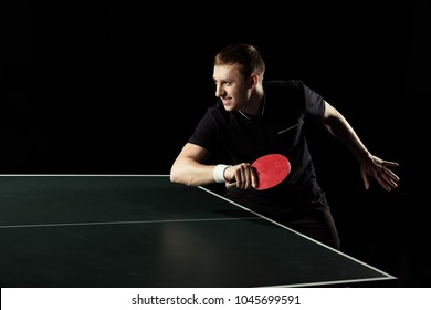 Side View Of Young Tennis Player Practicing In Table Tennis Isolated On Black