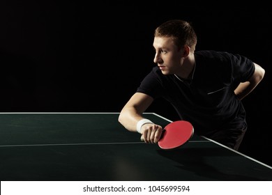 Side View Of Young Tennis Player Practicing In Table Tennis Isolated On Black