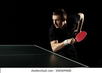 Side View Of Young Tennis Player Practicing In Table Tennis Isolated On Black