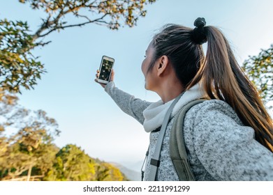 Side View Of Young Trekking Woman With Eyeglasses Standing And Use Smartphone Selfie With Beautiful View At View Point, Copy Space