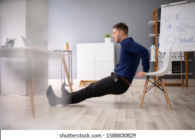 Side View Of A Young Woman Doing Stretching Exercise In Office