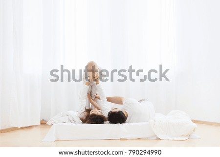 Similar – Relaxed mother and sons playing over the bed