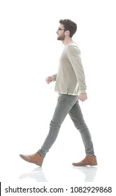 Side View.Young Smiling Man Walking Forward