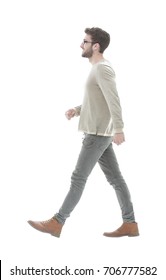 Side View.Young Smiling Man Walking Forward