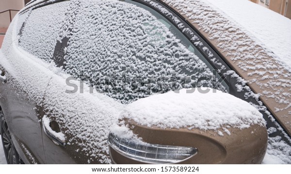 The side window of the car covered with beautiful\
snow flakes