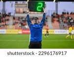Sideline referee shows 2 minutes added time during the football match.