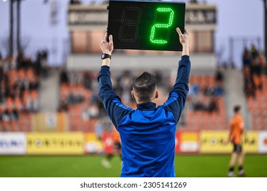 Sideline referee shows 2 minutes added time during the football match. - Shutterstock ID 2305141269