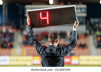 Sideline referee shows 4 minutes added time during the football match. - Shutterstock ID 2212047505