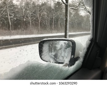 Sidemirror of Car in wintertime