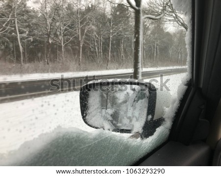 Sidemirror of Car in wintertime