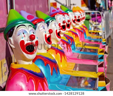 Sideshow game put the ball in the rotating clown's mouth and win a prize at a country show