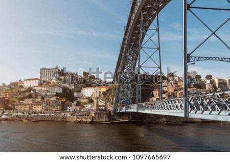 Blonde woman looks at bridge in Porto